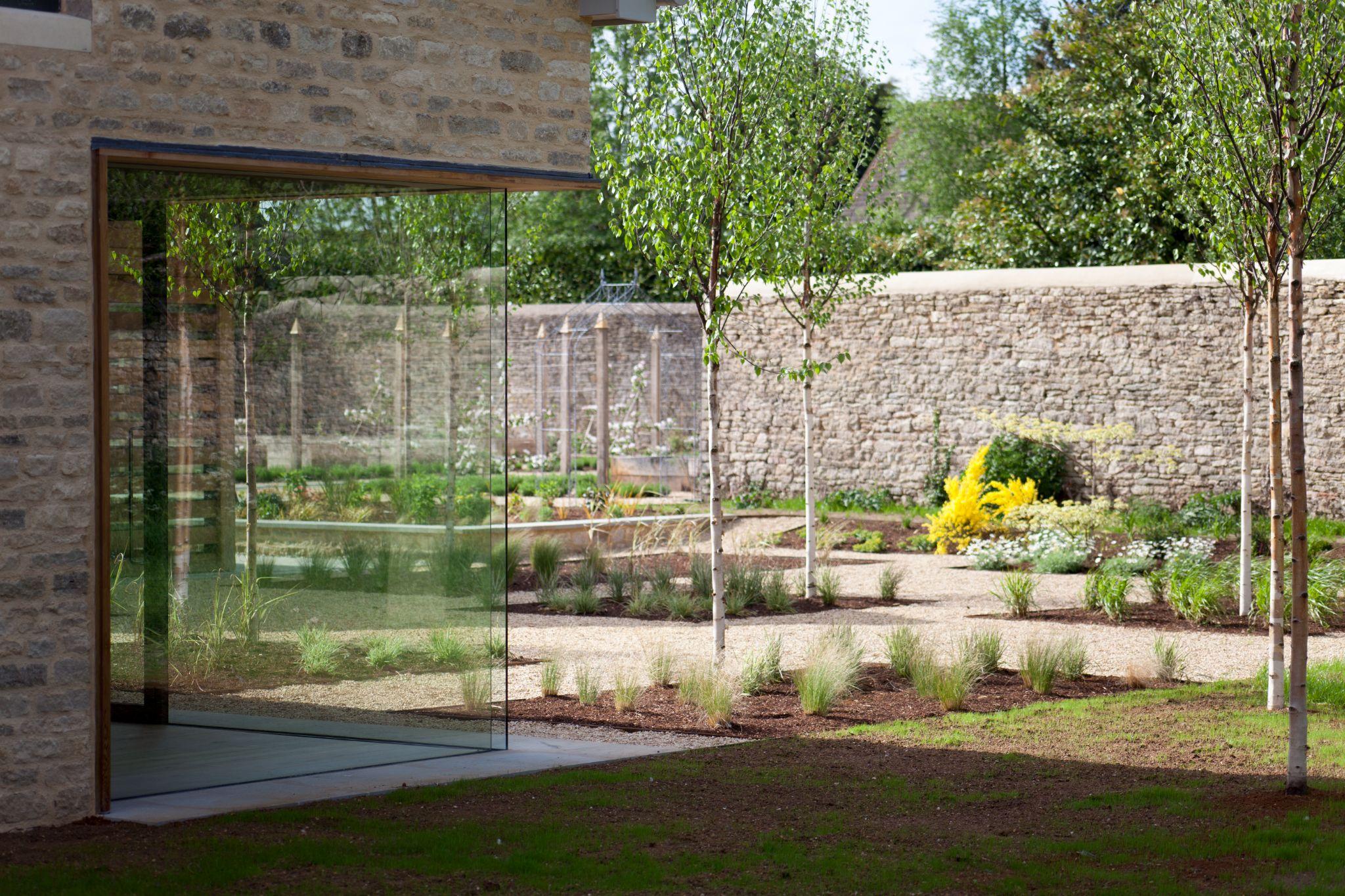 Corner glass to show off the newly planted garden.